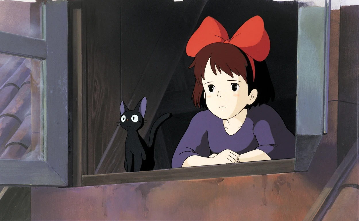 The protagonist looks sad, with a black cat on her side