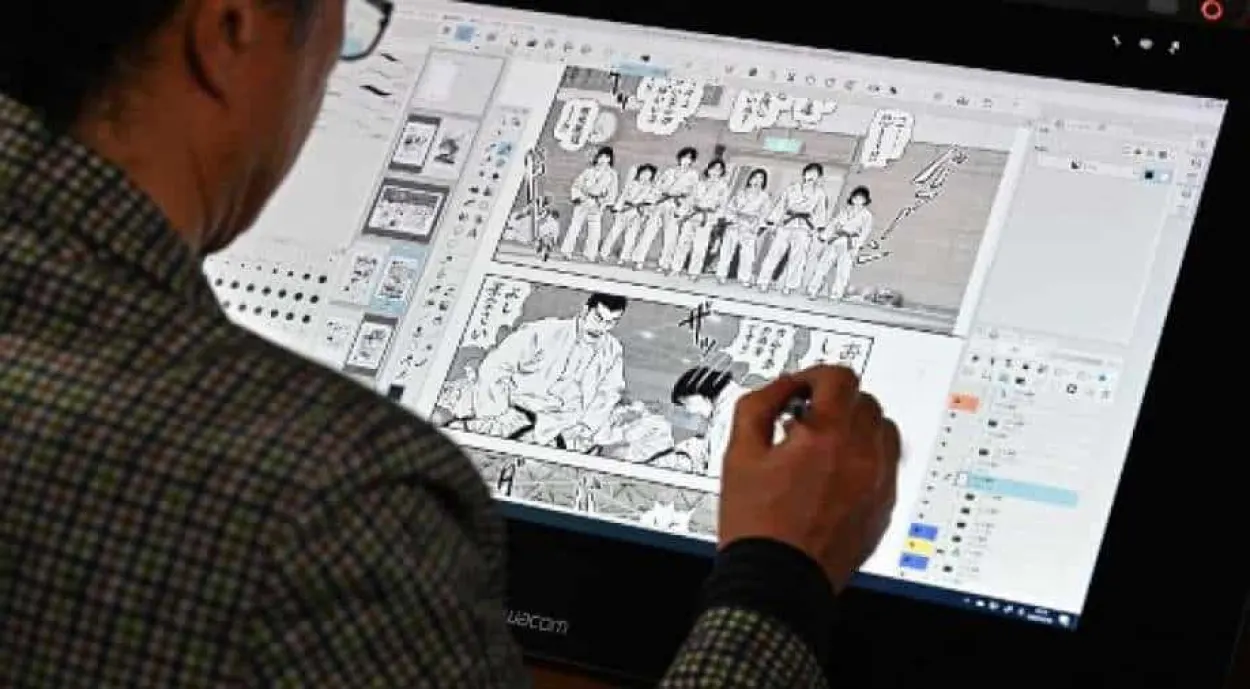 Mangaka drawing on a large screen