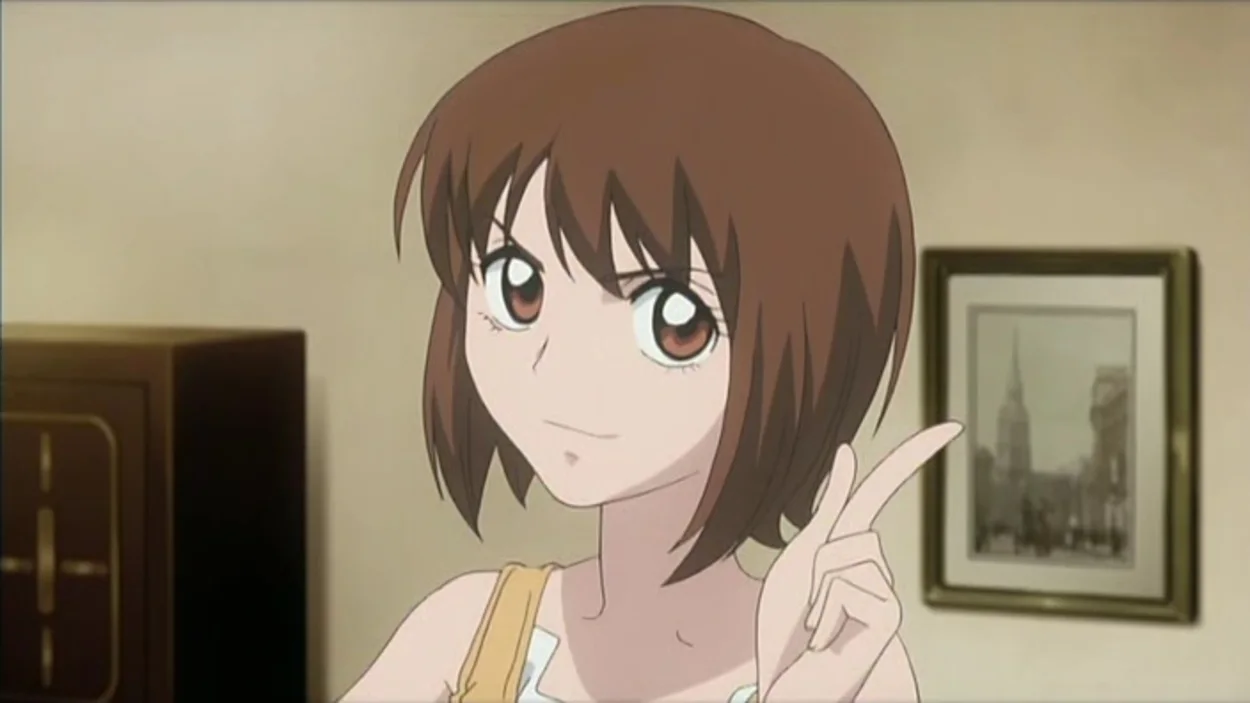 Mai Taniyama grins and signs with her index finger and thumb.