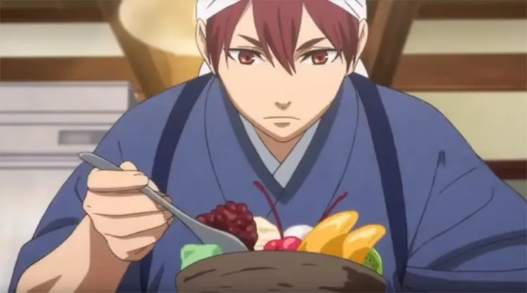 An anime character with red hair eating from a bowl with a spoon